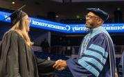 President Brian O. Hemphill, Ph.D., congratulates a student