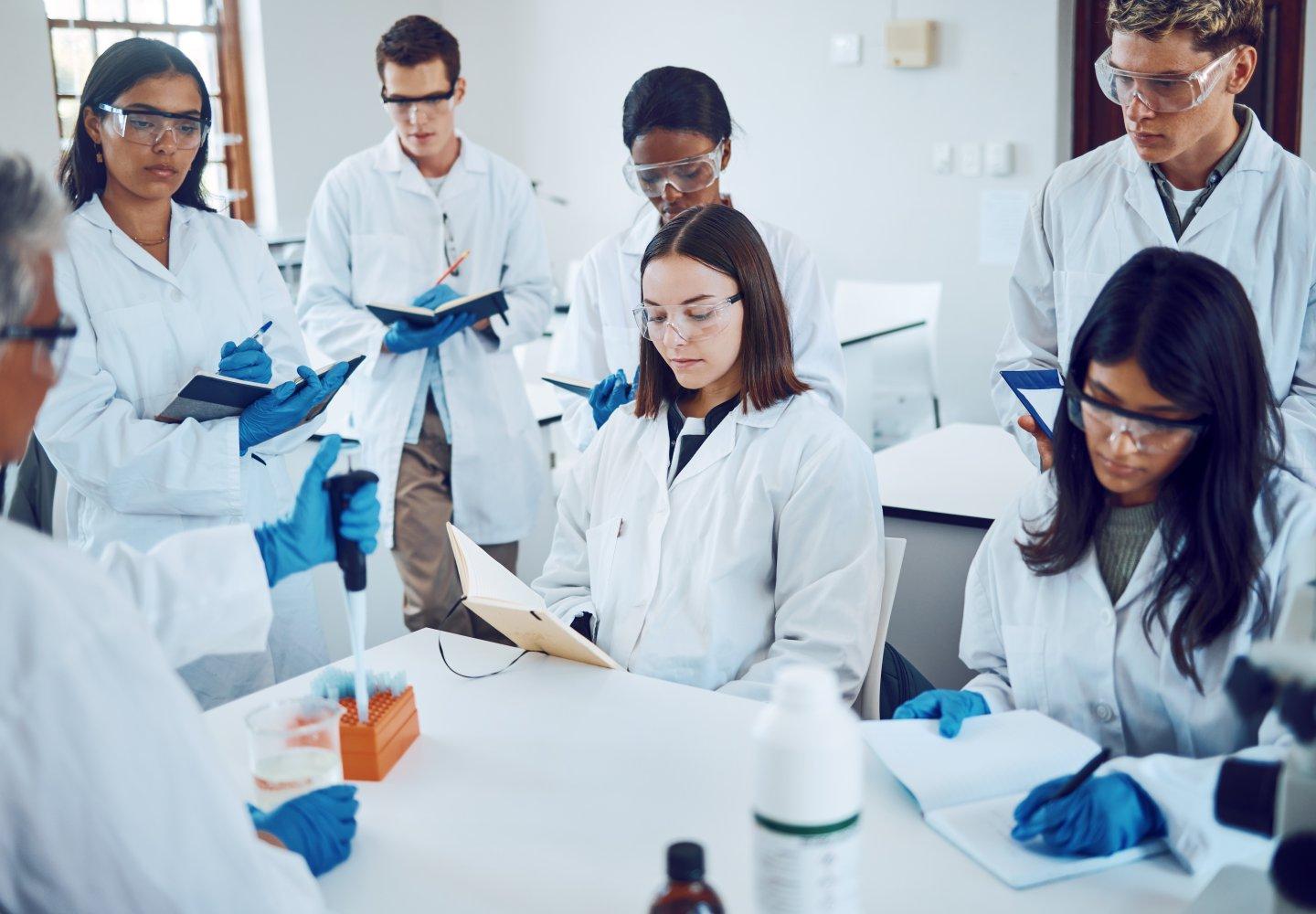 Science students writing notes in a laboratory